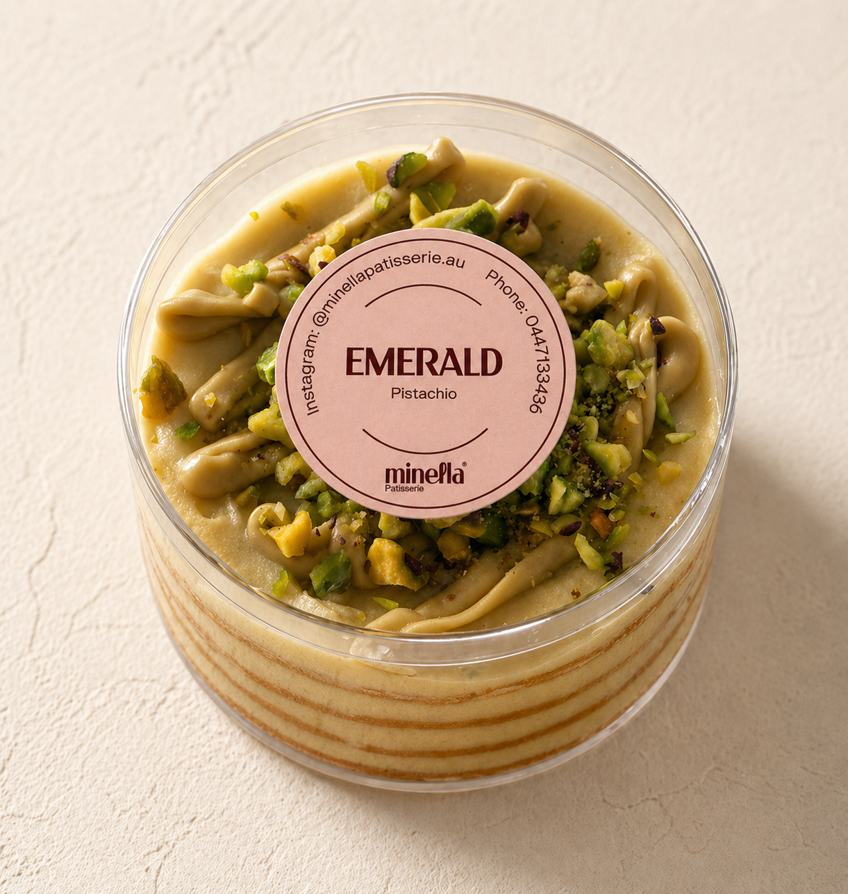 Pistachio layered Honey Cake with a slice removed, showing its interior layers.